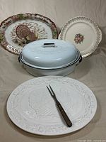Group view of roaster, three platters, fork