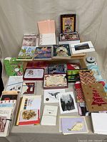 Overview of lap tray covered with assorted greeting cards, note cards, envelopes, gift bags and ribbon spool