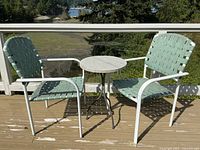 Full view of table and two chairs on deck