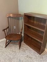 Rocking chair beside bookcase showing size and finish