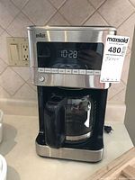 Full view of Braun coffee maker showing display, controls, and MaxSold tag