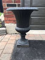 Front view of cast iron pedestal planter