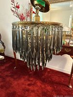 Full view of chandelier hanging, showing prisms and canopy