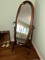 Full view of oval cheval mirror on stand