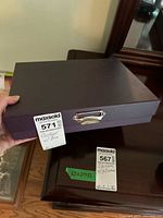 Closed purple jewelry case with handle