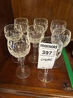 Eight cut crystal wine glasses on shelf