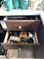 Two drawers open showing utensils and gadgets