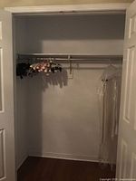 Closet view with hangers on rod