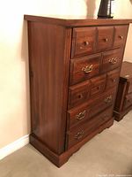 Front and side view of dresser showing wood finish and overall form