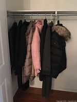 All six coats hanging on closet rod