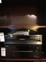 Front view of Onkyo DX-C390 CD changer on shelf