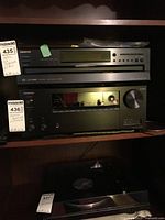 Front view of ONKYO receiver in shelving unit
