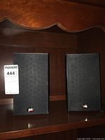 Front view of both PSB Image B4 speakers on shelf