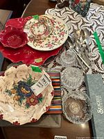 Overview of lot showing ceramic platters, bowls, glassware and utensils