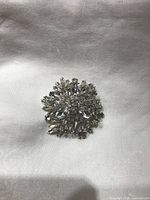 Front view of round rhinestone brooch