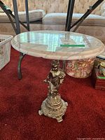 Full view of side table with marble top and metal base