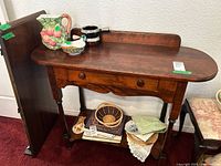 Front view showing table top, drawer, legs, lower shelf