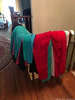 Clothing draped over banister showing variety of colours and types