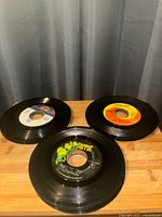 Three records showing Parrot, white and orange labels