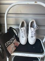 Full view sneakers on step stool with tote bag