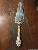 Full view of cake pie server showing handle and blade