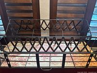 Top view of wrought iron window planter showing lattice sides and internal supports