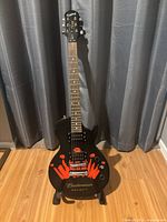 Full view of Epiphone Special II Budweiser Select guitar standing upright