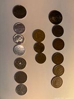 Overview of all fourteen coins laid out in three columns