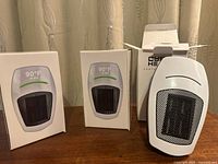 Three boxed heaters and one unboxed unit front view