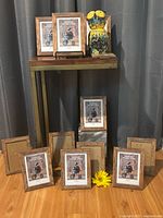 Group of twelve wood frames displayed with ceramic owl