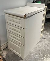 Front and side view of cabinet showing drawers and laminate top