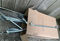 Box containing multiple galvanized telescoping arms