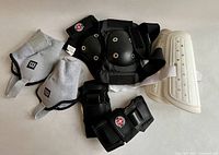 All eight pieces laid out: wrist guards, elbow/knee pads, shin guards, ankle guards