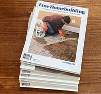 Stack of Fine Homebuilding magazines showing cover with tile grouting article
