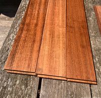 Group of hardwood tongue-and-groove planks showing color and finish