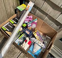 Full lot inside cardboard box showing various light bulb packages and 48-inch tube