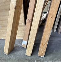 Ends of three dimensional lumber pieces showing wear