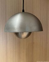 Front view showing exterior brushed silver finish and two-dome design