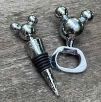 Bottle stopper and opener showing Mickey Mouse ear tops
