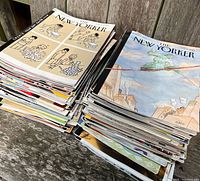 Two stacks of The New Yorker magazines on wooden surface