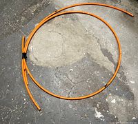 Both coiled orange PEX lengths on floor