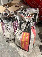 Overall view of two opened Sakrete Non-Shrink Grout bags and one Sakrete Mortar Mix bag