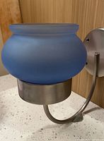 sconce with blue glass shade mounted, side view