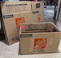 Flattened and assembled Home Depot small moving boxes showing logo, size marking and clean condition