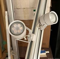 Close-up of two track heads mounted on white rail