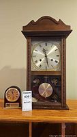 Front view of Centurion pendulum clock and Howard Miller desk clock