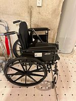 Full view of Drive manual wheelchair with large rear wheels and folded footrests