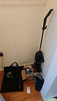 Entire lot showing vacuum on charging base, accessories on floor