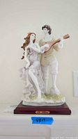 Front view of porcelain figurine showing couple and guitar
