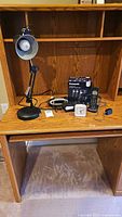 Desk shelf with lamp, telephones, clock and Panasonic box